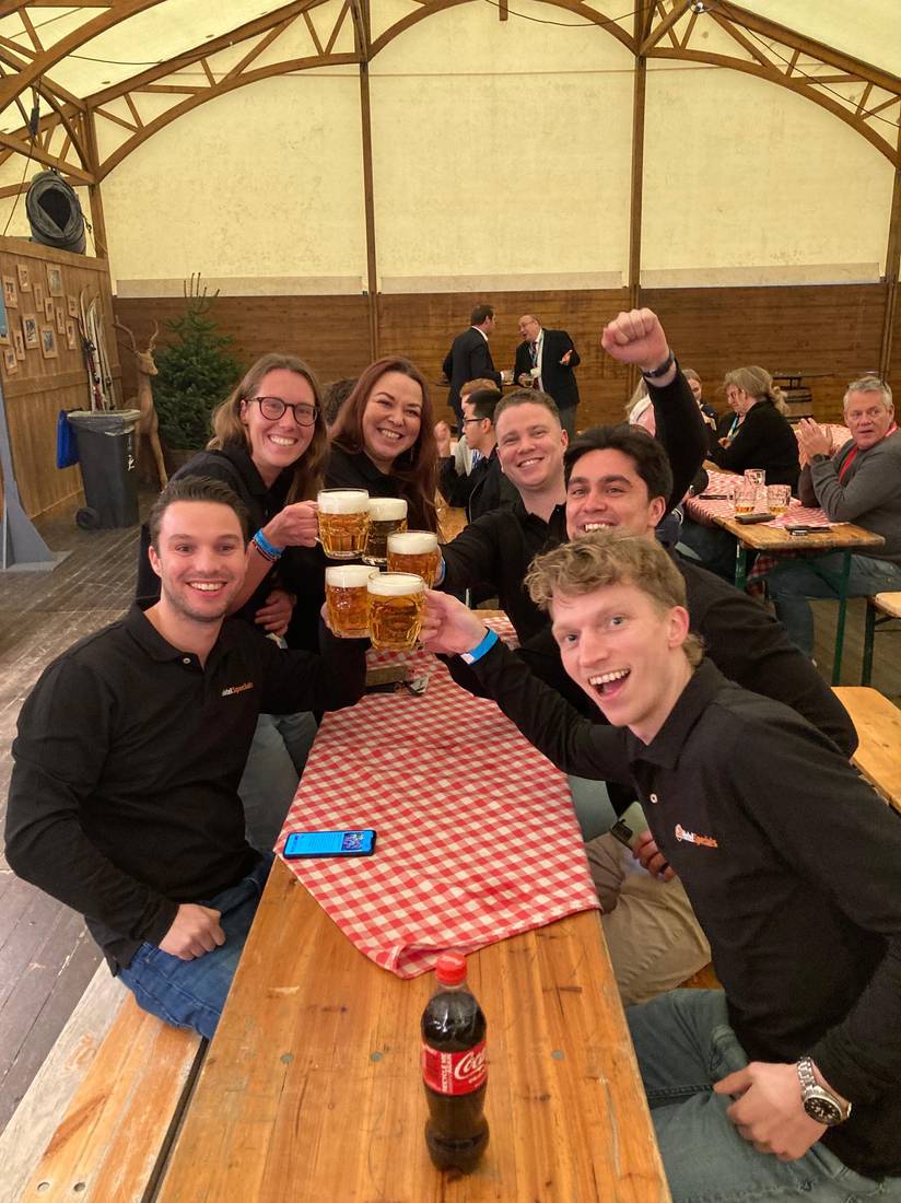 Team toasting with beer steins at an Oktoberfest event
